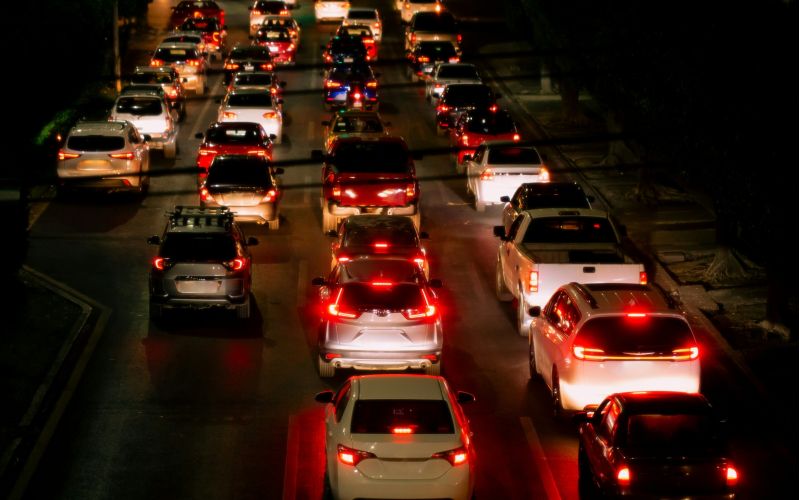 a crowded highway at night with lots of brake lights showing