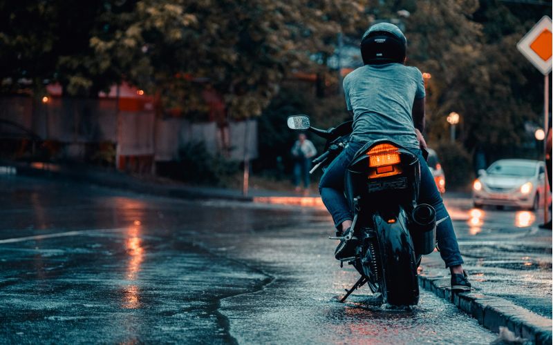 motorcycle parked on wet city street at night