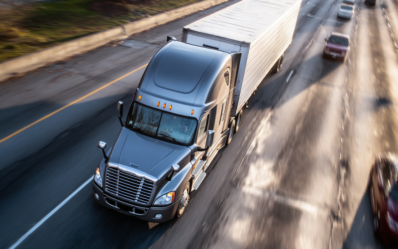 bird's eye view of a semi truck traveling down an interstate