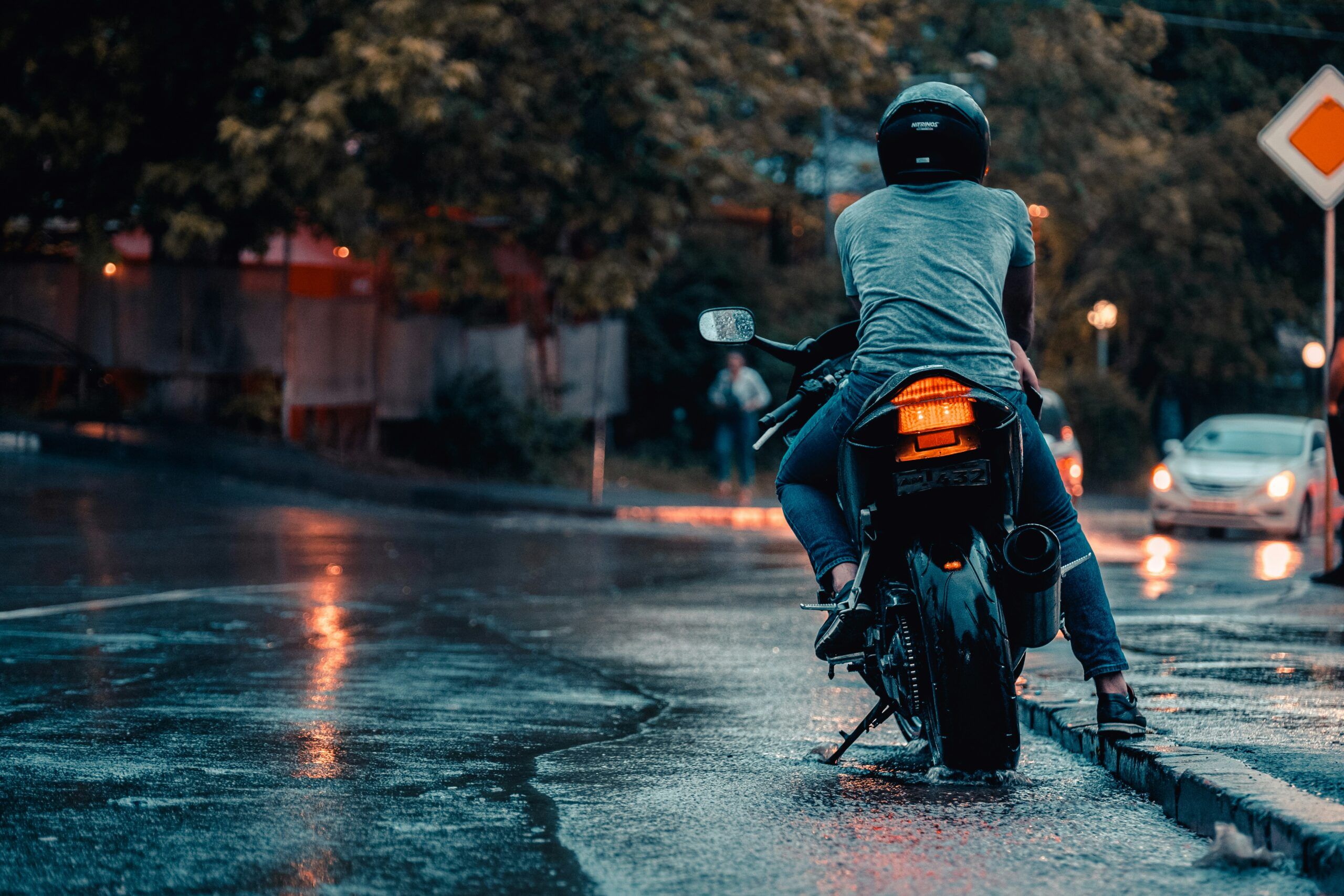 motorcycle parked on wet city street at night