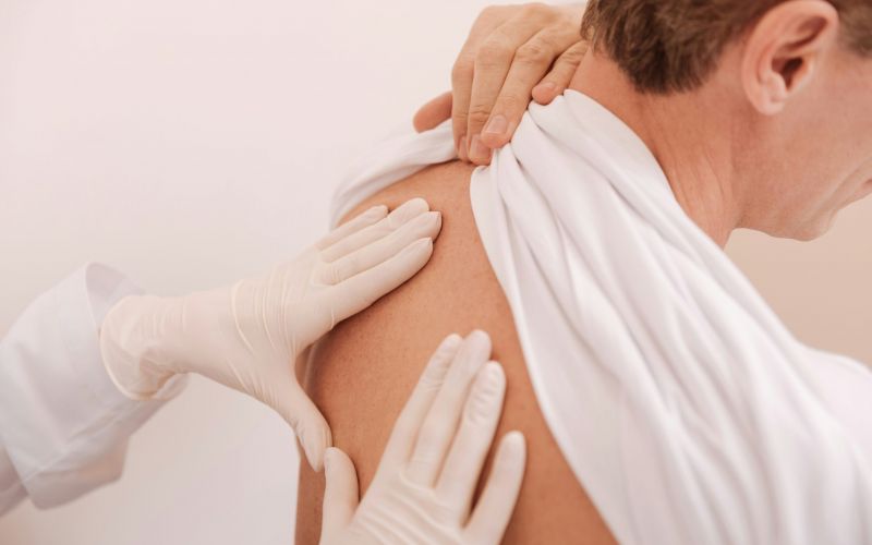 doctor examining patient's back