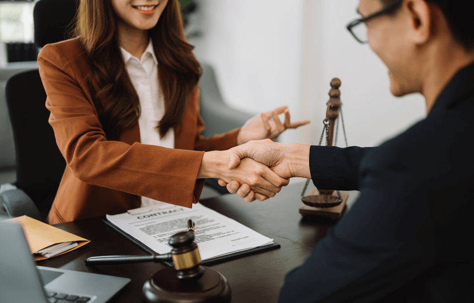 woman shaking hands with her attorney