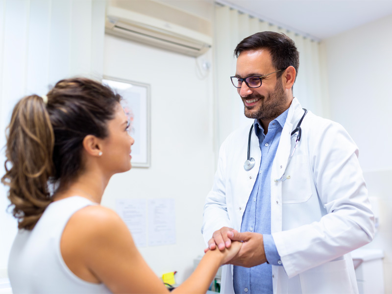 male doctor talking to a female patient