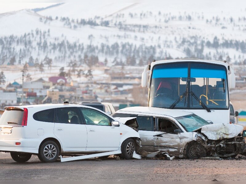 bus colliding into the side of a car