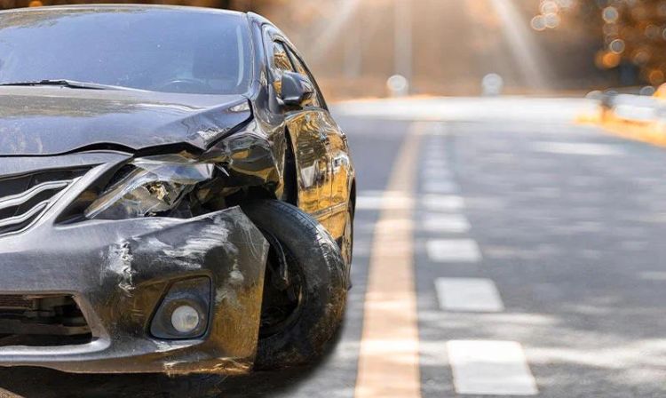 car with front end damage in the road