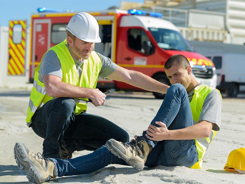 construction worker with an injured ankle waiting for paramedics