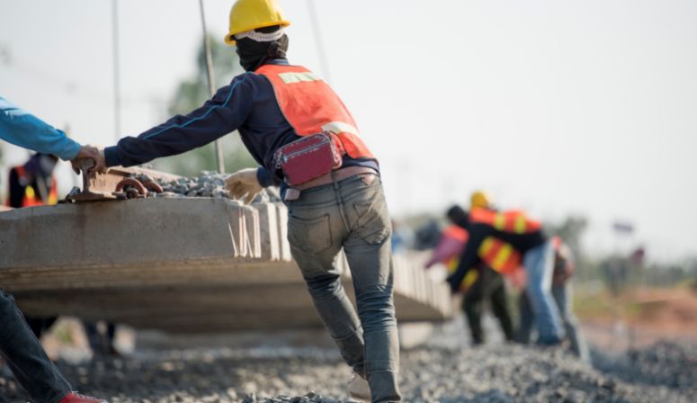 construction workers moving cement