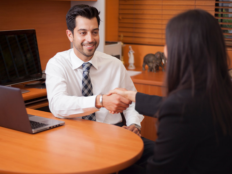 man shaking hands with a woman