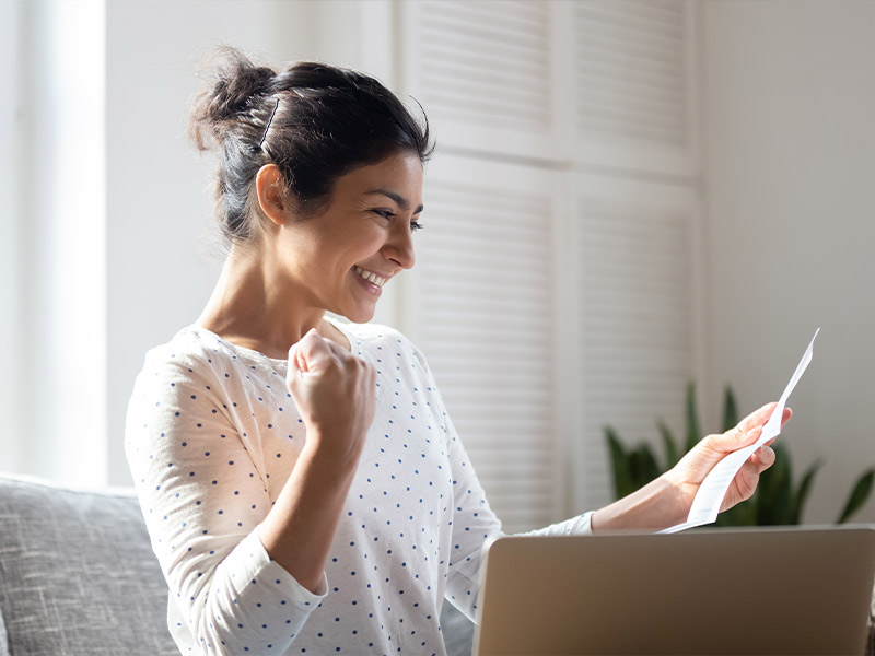 Woman looking at a piece of paper in excitement