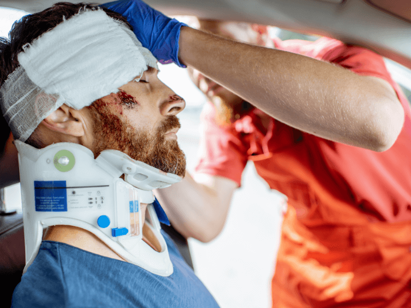 Man receiving medical attention after a car accident