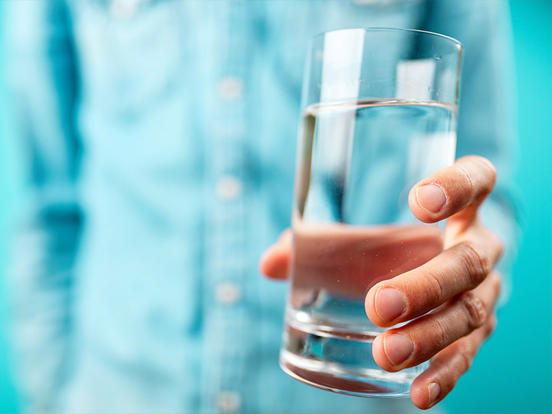 woman holding a glass of water