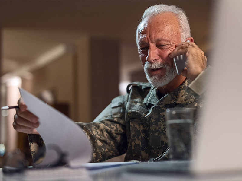 elderly soldier looking through paperwork