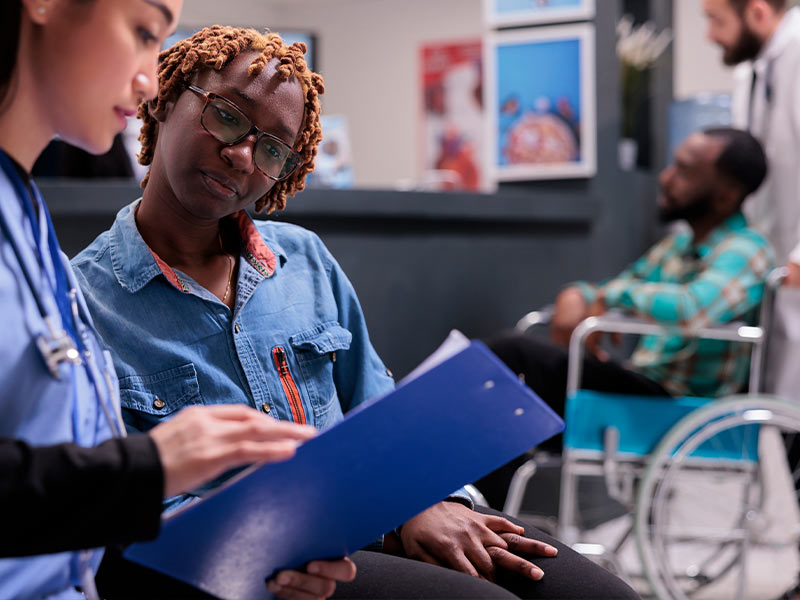 nurse showing a patient her lab results