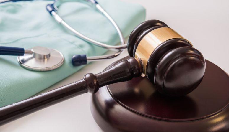 gavel on table next to stethoscope