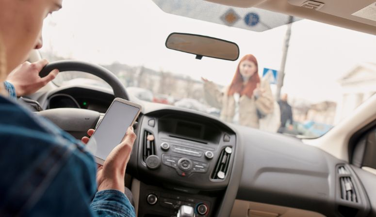 woman crossing road in front of car