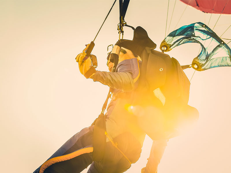 Man pulling his parachute while skydiving