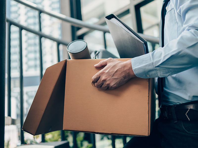 office worker leaving their job with a box 