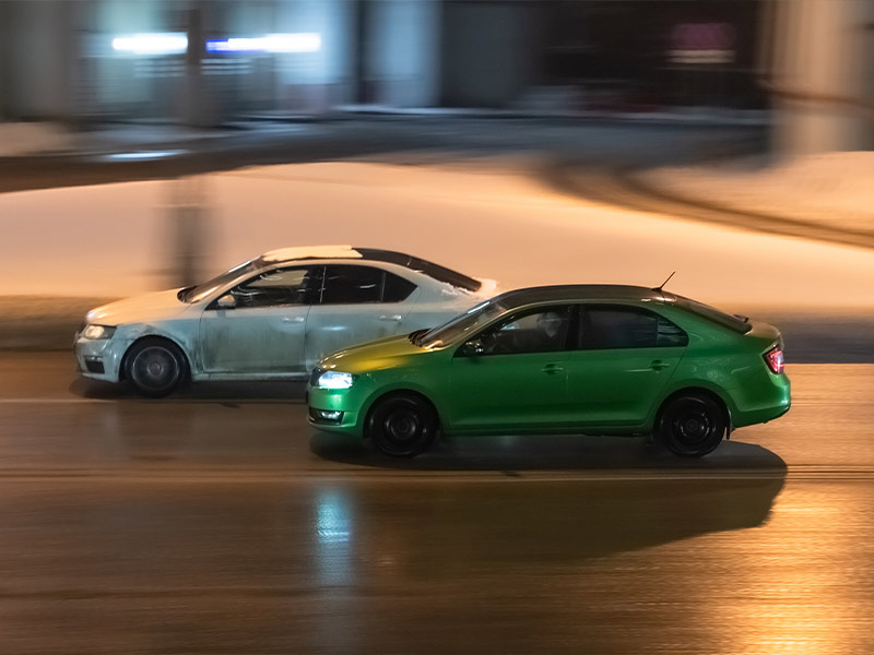 a car passing another car in the left lane