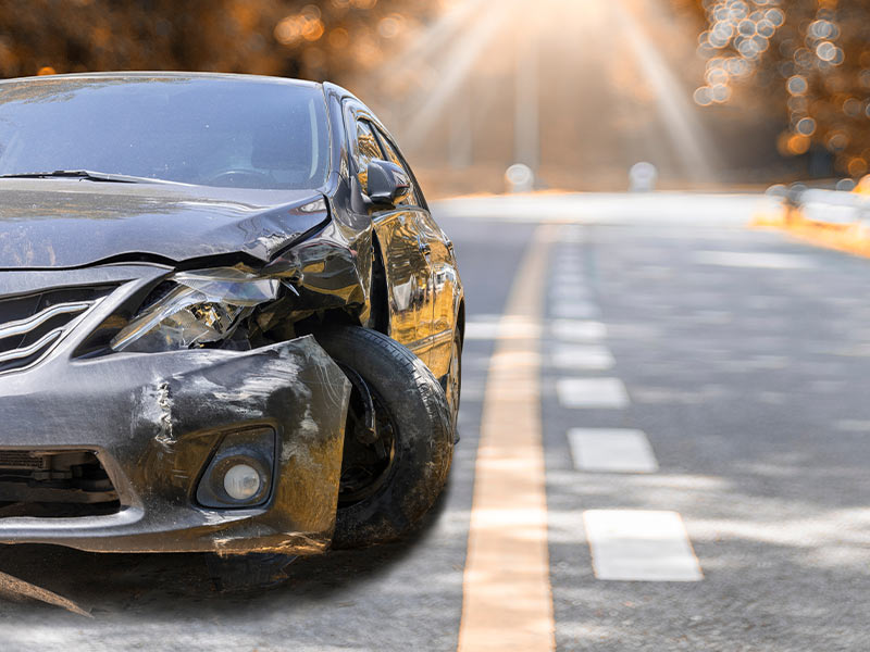 car with front end damage in the road