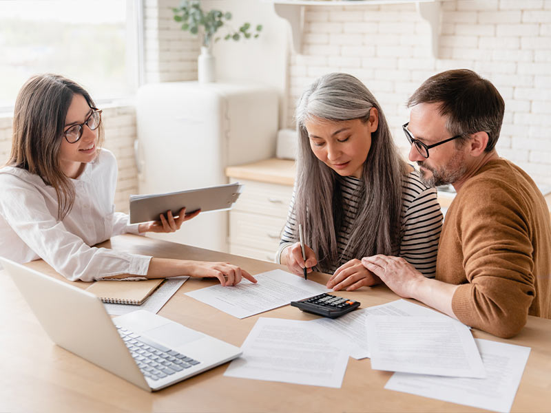 attorney helping a man and a woman with their finances