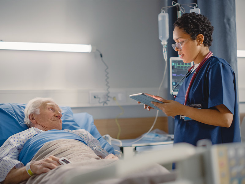 A doctor standing next to a patient in the hospital 