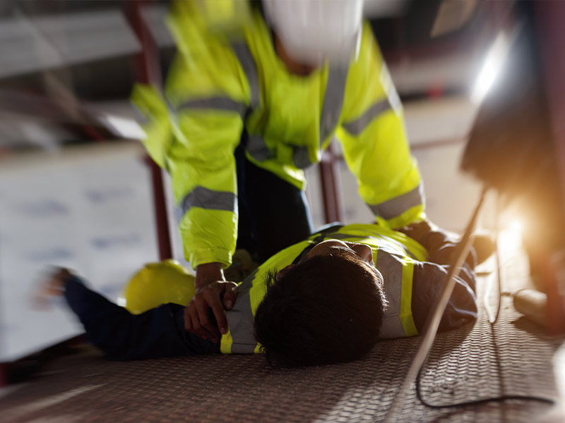 an injured worker being helped up