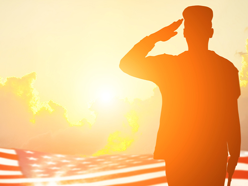 soldier saluting an American flag