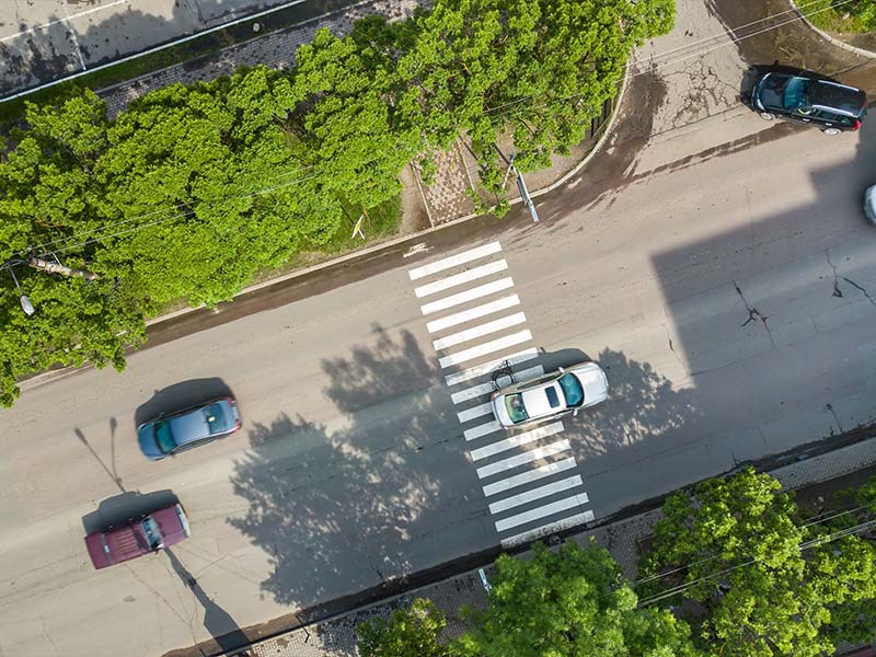 overview of cars driving through crosswalks
