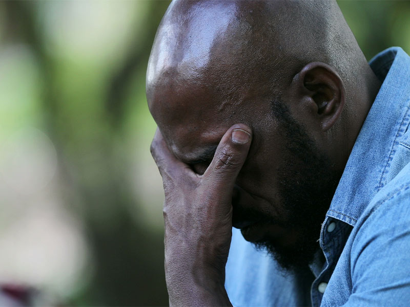 upset man holding his hand on his head