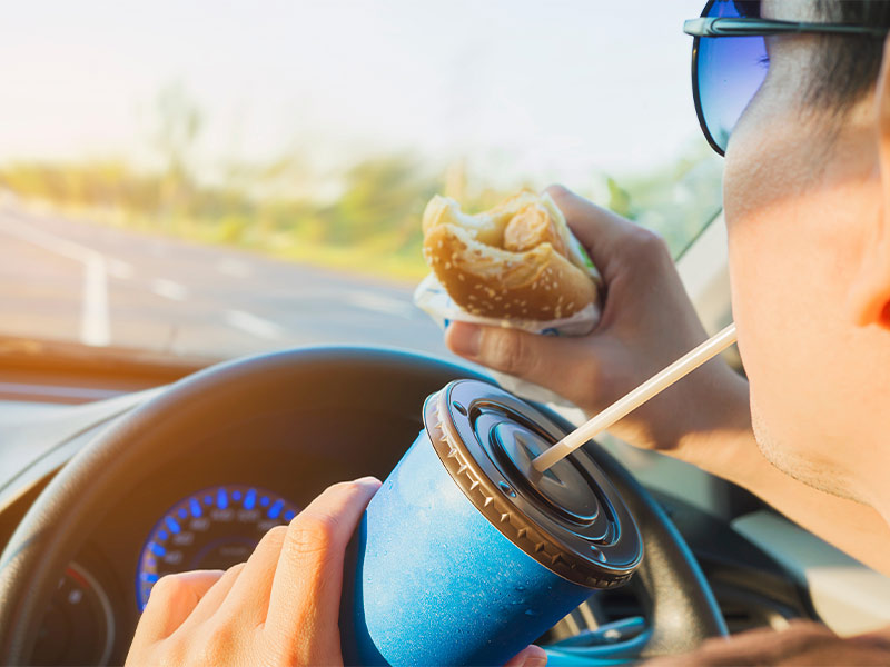 man driving while eating 