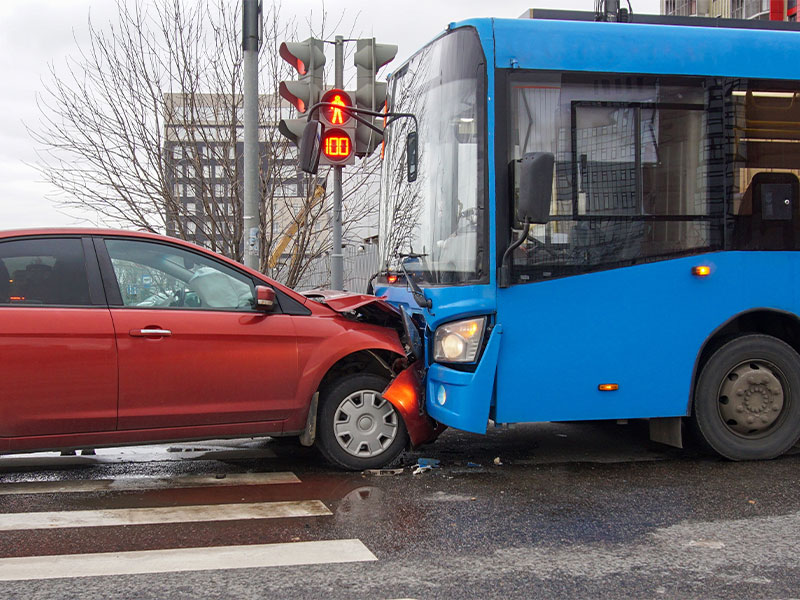 Car in a head on collision with a city bus