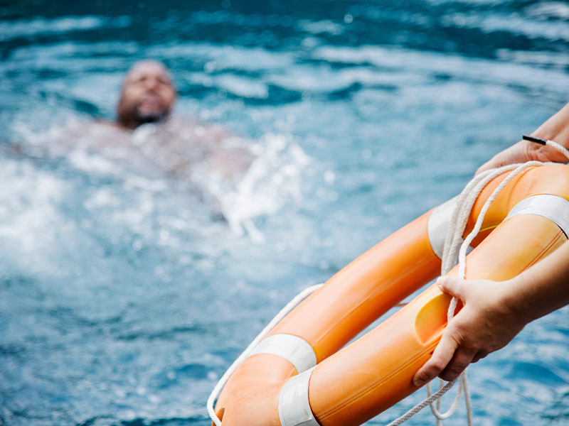 lifeguard throwing a rescue buoy