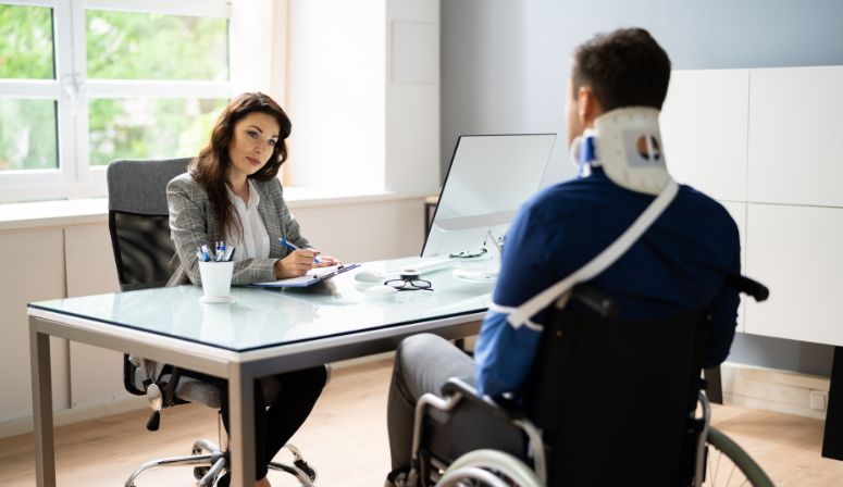 man in wheelchair at desk