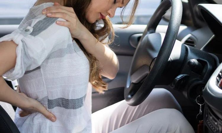 Woman holding her back in pain after an auto accident
