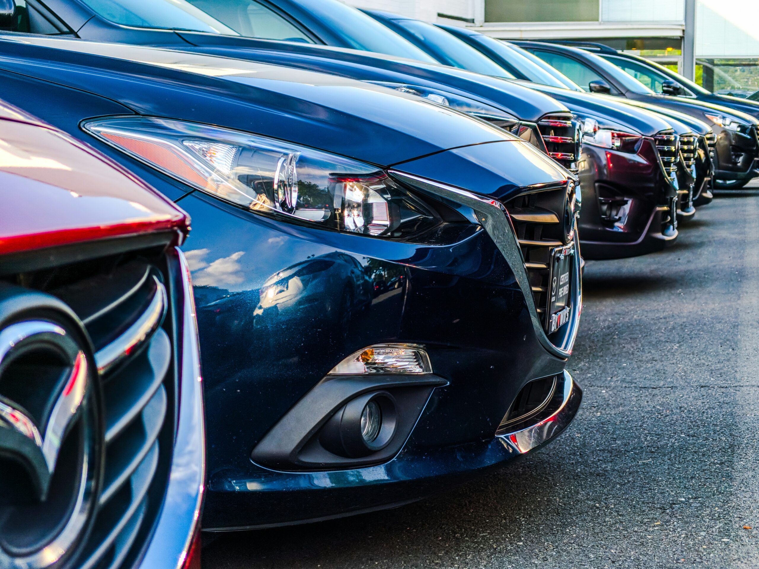 a parking lot filled with gleaming rental cars