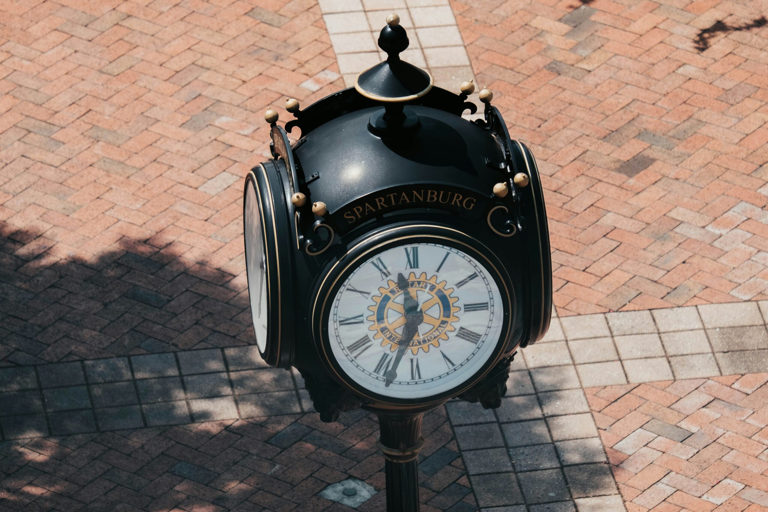 A decorative black clock that says "Spartanburg" 